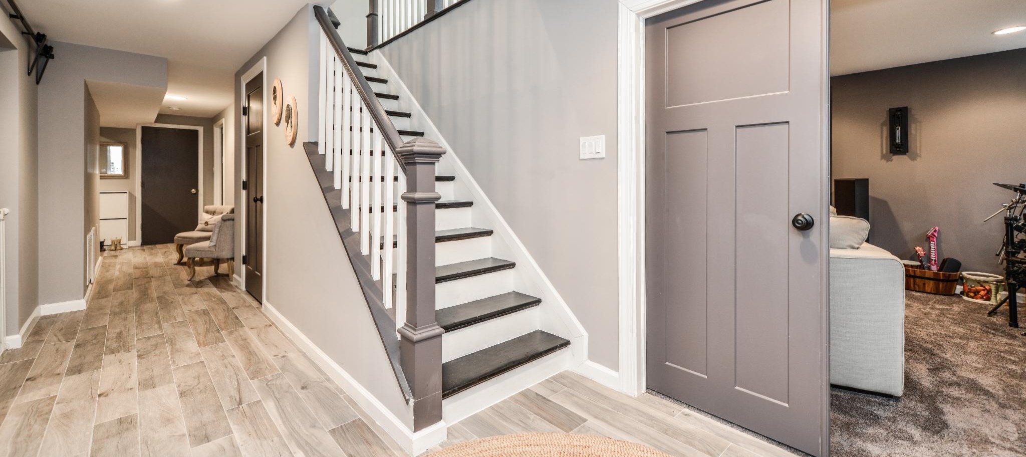 A remodeled basement with new stairs and a sliding door