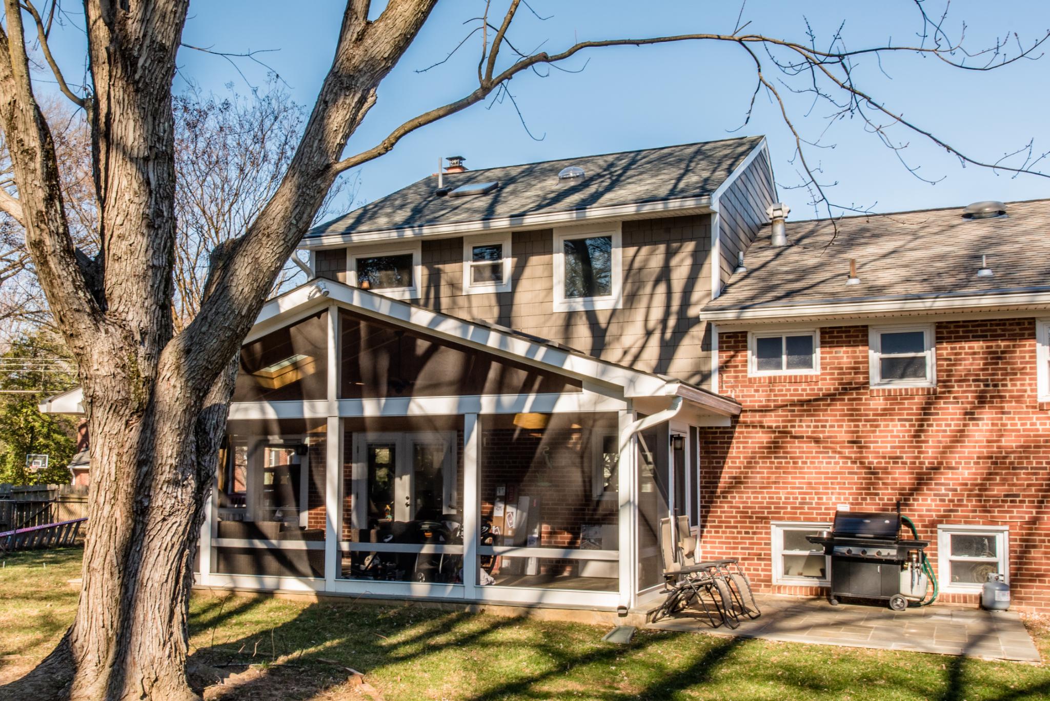 New sunroom added to the back of a brick house