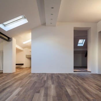 Remodeled attic with white walls and vinyl floor