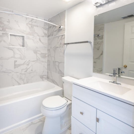 A spotless, all-white remodeled Northern Virginia bathroom